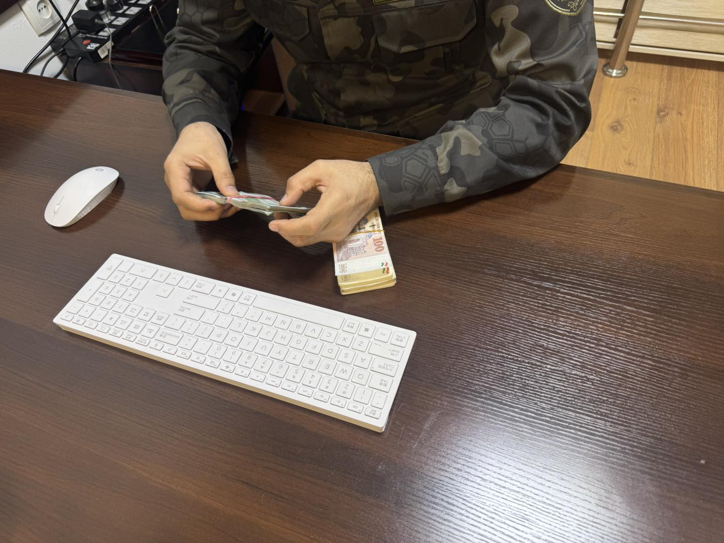 A military enlistment office officer is accused of accepting a bribe for a deferment from military service.