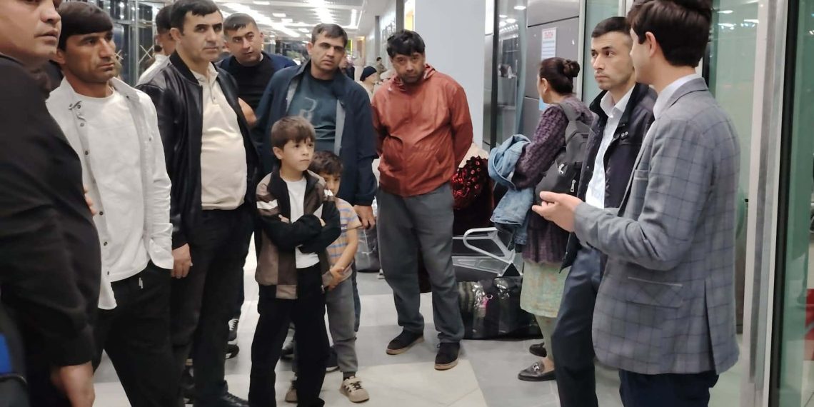 At Dushanbe Airport, migrants are being briefed on employment and work rules in Russia.